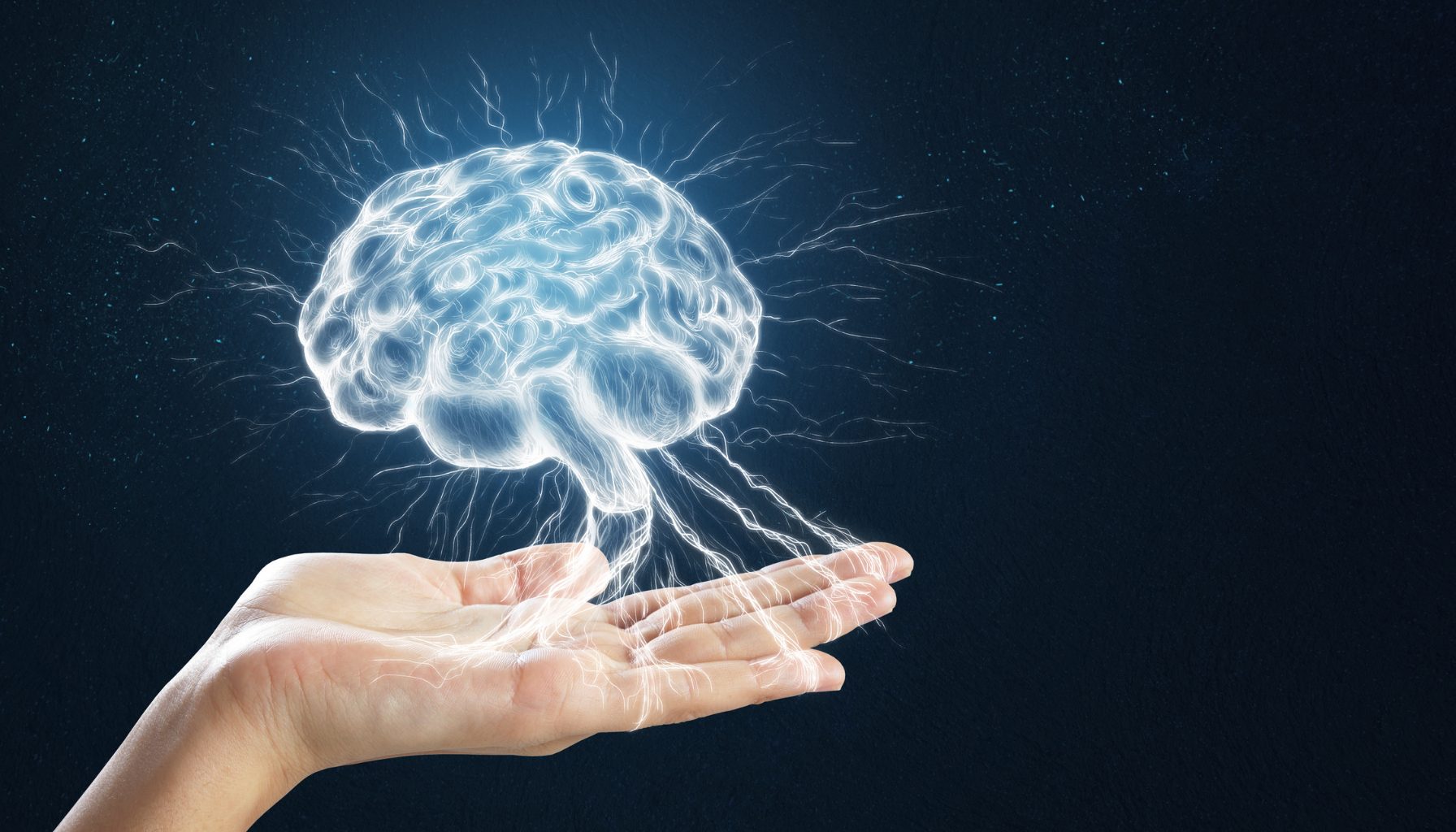 Human hands holding a glowing brain made of light, symbolizing neuroplasticity, learning, and the power of mindset.